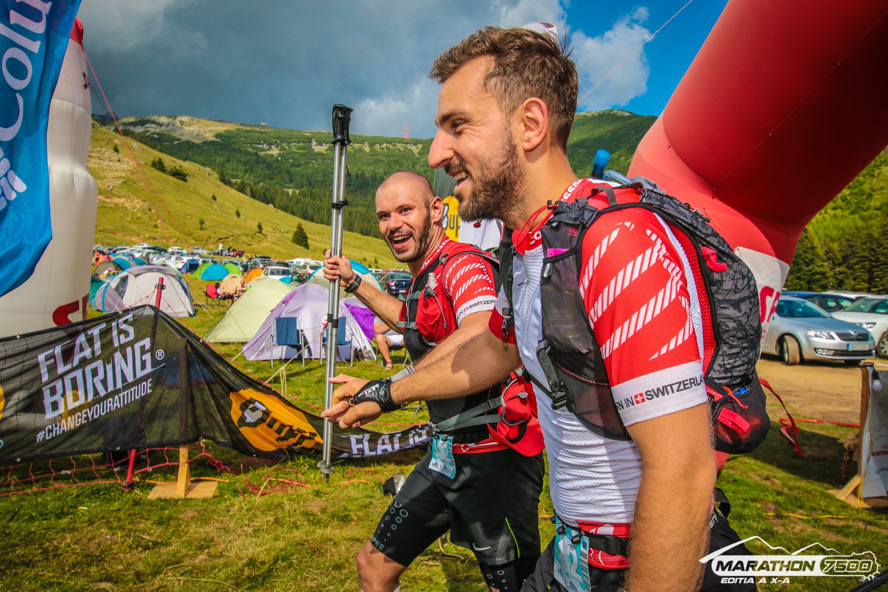 Trail runners climbing rocky mountain terrain